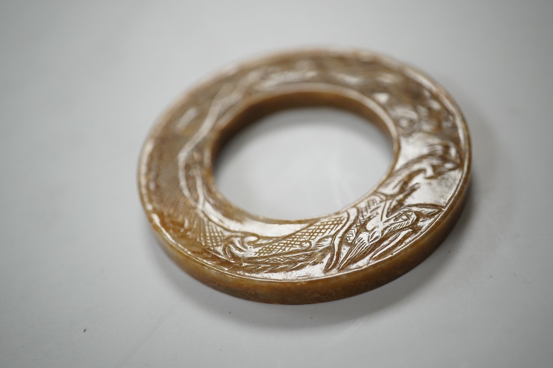 A Chinese russet jade dragon disc, 5.5cm diameter